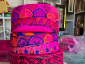 Pink Mithila Paag with traditional colorful artwork